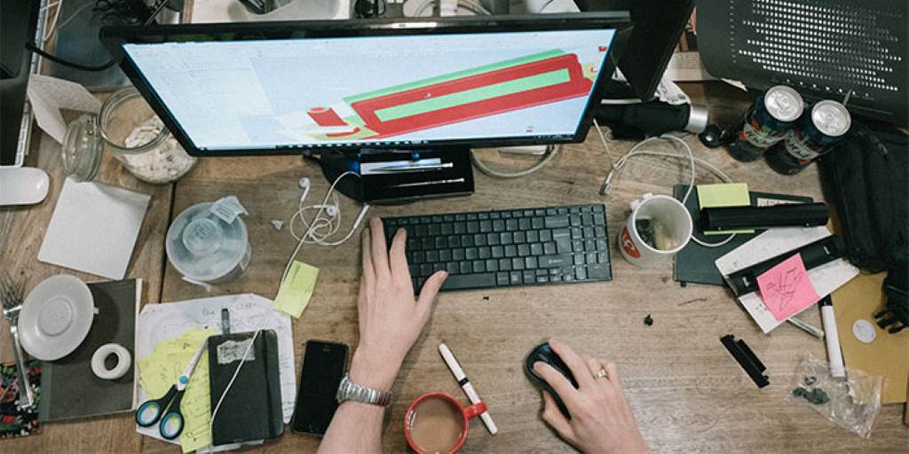 Creator brainstorming micro-SaaS ideas on a laptop in a cozy workspace.